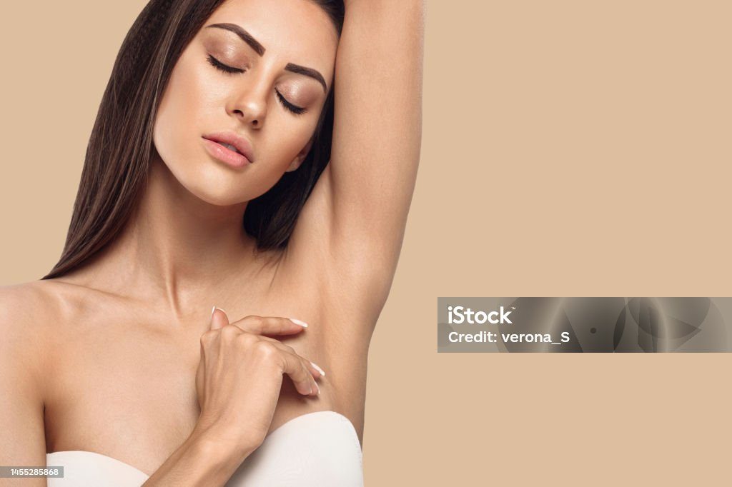 Armpit epilation, lacer hair removal. Young woman holding her arms up and showing clean underarms, depilation smooth clear skin .Beauty portrait
